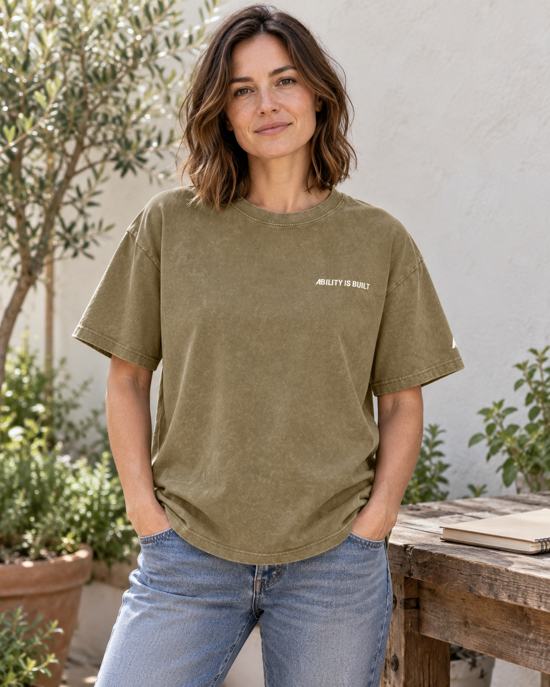 AI-generated lifestyle mockup of the AIB Gray Green washed T-shirt worn by an adult model